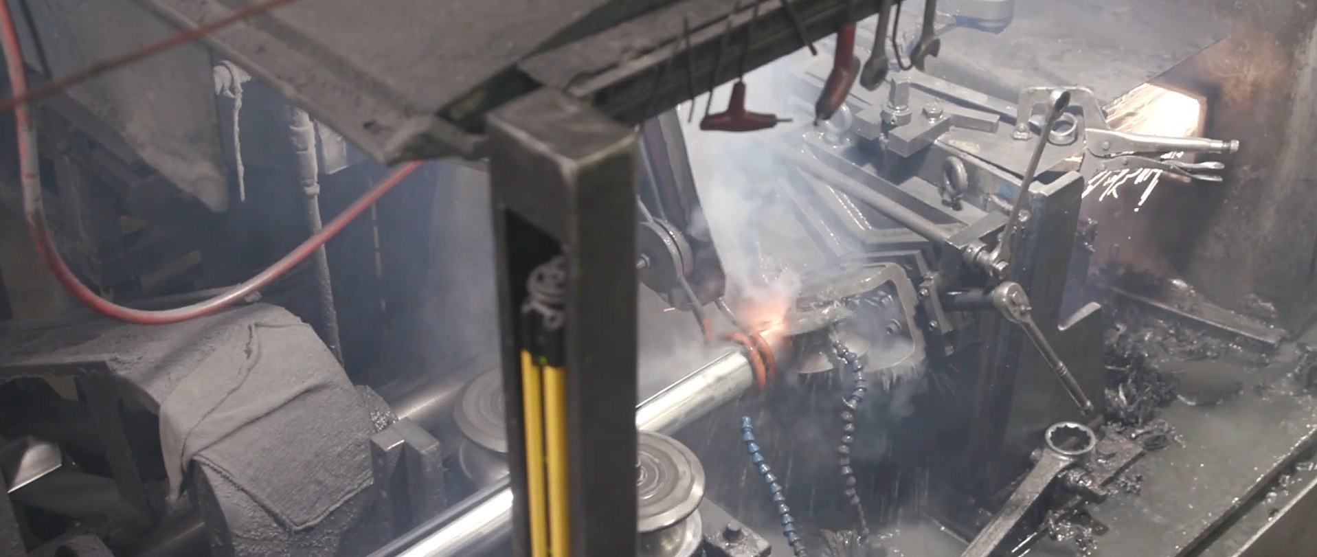 ERW welding station forming square steel tube — sparks visible at the weld point on the in-house tube mill in Mansfield, Ohio