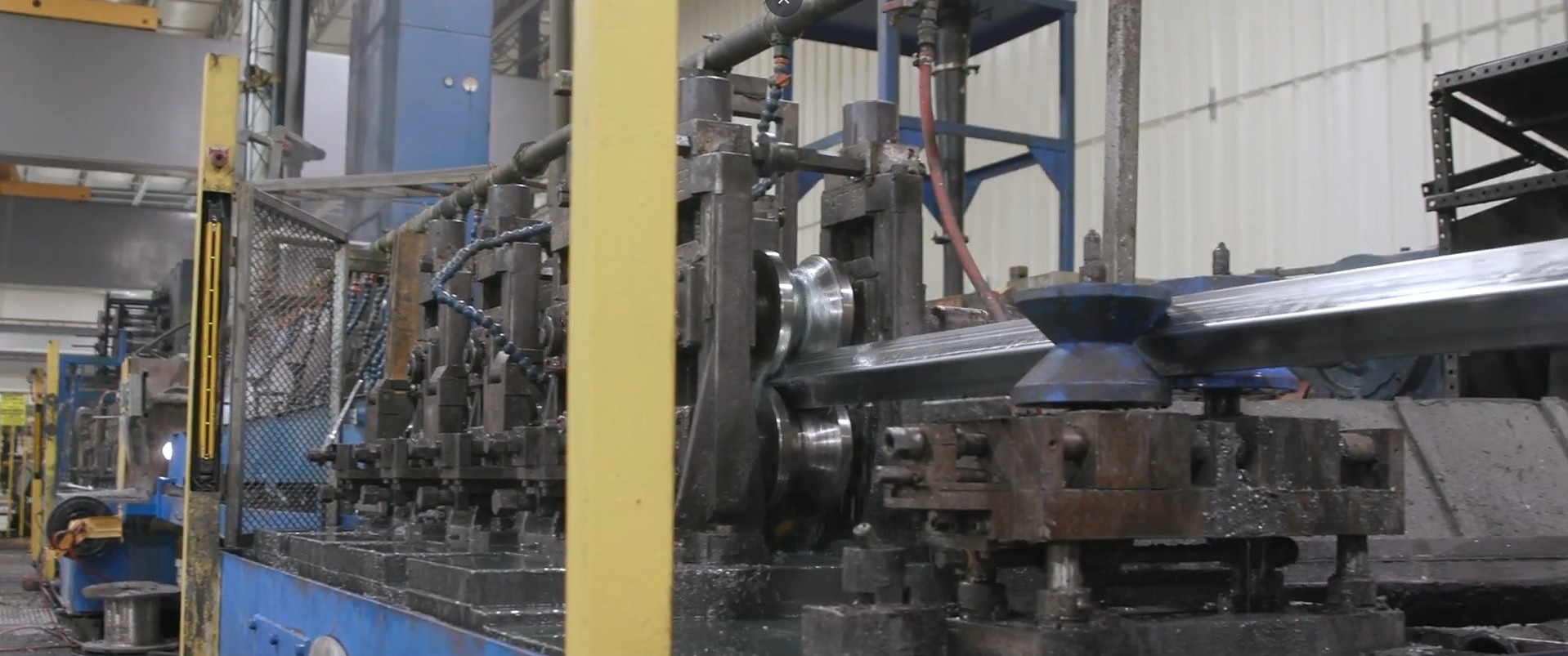 Steel strip being formed into square tube on the in-house ERW tube mill at Major Metals in Mansfield, Ohio